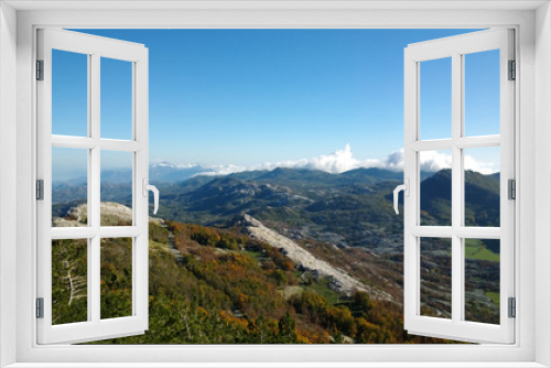 Panoramic view of autumn mountains Lovcen in Montenegro. Views of the peaks of the hills, the colorful trees and stones