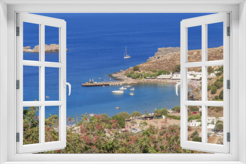 Fototapeta Naklejka Na Ścianę Okno 3D - Panoramic view of small sandy beach in Lindos town at island Rhodes on sunny day
