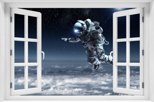 Fototapeta Naklejka Na Ścianę Okno 3D - Astronaut floating above clouds