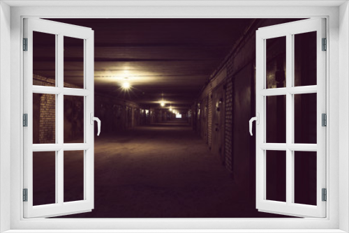 Fototapeta Naklejka Na Ścianę Okno 3D - Dark long hallway with metal gates and working bulbs
