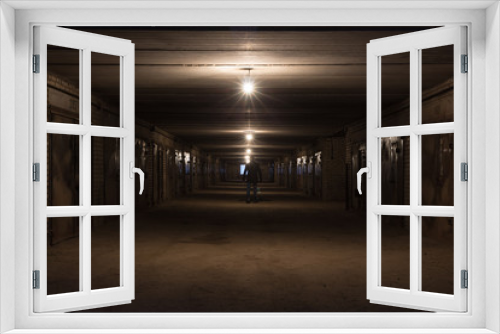 Fototapeta Naklejka Na Ścianę Okno 3D - Man in the long hallway with metal gates