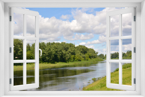 Fototapeta Naklejka Na Ścianę Okno 3D - beautiful summer fairy tale, a bright summer natural landscape, the Dvina river against a blue sky with white clouds