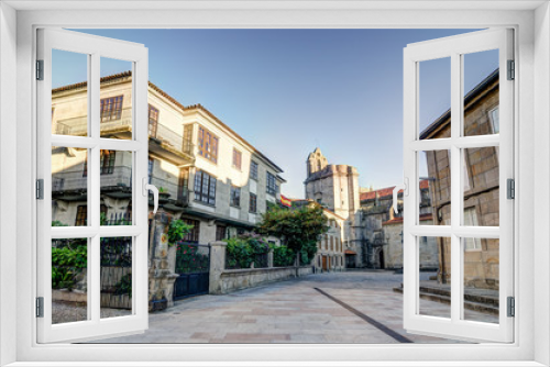 Fototapeta Naklejka Na Ścianę Okno 3D - A square in Pontevedra (Spain) with a church as background and some buildings with plants and a spanish flag