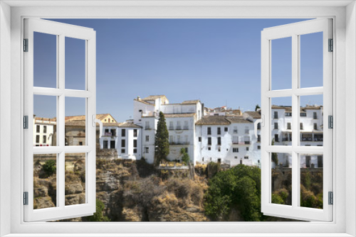 Fototapeta Naklejka Na Ścianę Okno 3D - view from the mountain to the bridge, fields and houses. White houses in Spain. View of Ronda, Spanish Moor town - Ronda, Malaga, Andalusia, Spain