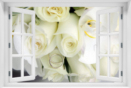 Fototapeta Naklejka Na Ścianę Okno 3D - background of beautiful wedding bouquet of roses and orchids and two gold and platinum wedding rings