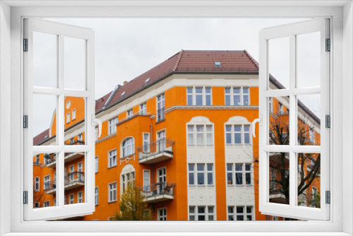 Fototapeta Naklejka Na Ścianę Okno 3D - orange corner building with grey sky
