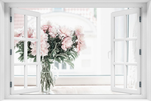 Fototapeta Naklejka Na Ścianę Okno 3D - Beautiful pastel pink bouquet of peonies in glass vase on windowsill. Flowers in interior design. Cozy home.