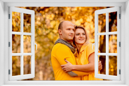 The husband embracing his wife and standing in the forest