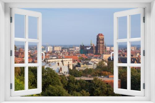 Fototapeta Naklejka Na Ścianę Okno 3D - Buildings at the downtown, Main Town (Old Town) and beyond and St. Mary's Church in Gdansk, Poland, viewed from above on a sunny day in the summer.