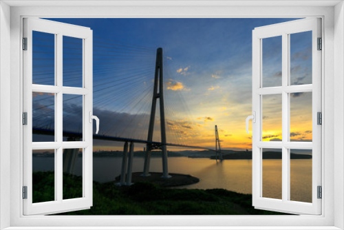 Fototapeta Naklejka Na Ścianę Okno 3D - Amazing zooming out aerial view of the Russky Bridge, the world's longest cable-stayed bridge, and the Russky (Russian) Island in Peter the Great Gulf in the Sea of Japan. Sunrise. Vladivostok, Russia