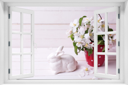 Fototapeta Naklejka Na Ścianę Okno 3D - Apple tree flowers in  red cup and  Easter bunny on white wooden background.