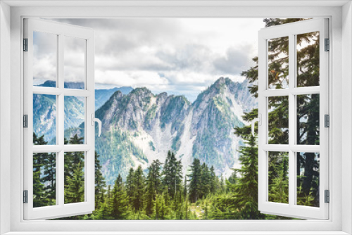 Fototapeta Naklejka Na Ścianę Okno 3D - Rocky mountains covered with green forest with blue sky and white clouds on the background
