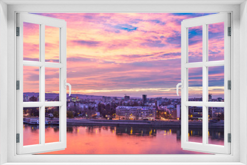 Cityscape with sunset and clouds.