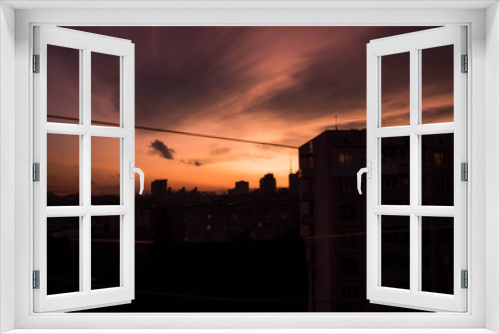 City roofs on sunset cloudy sky