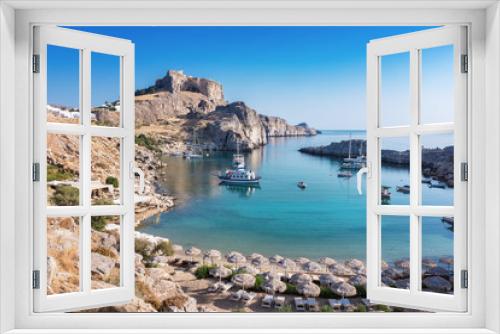 Fototapeta Naklejka Na Ścianę Okno 3D - St. Paul´s bay with boats, Lindos acropolis in background (Rhodes, Greece)