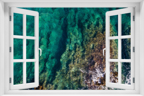 Fototapeta Naklejka Na Ścianę Okno 3D - Aerial view of the green waves that beat the sea cliffs