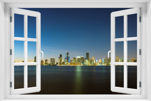 Fototapeta Naklejka Na Ścianę Okno 3D - USA, Florida, Bright shining night skyline of miami with reflections on water and starry sky