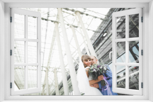 Perfect couple bride, groom posing and kissing in their wedding day