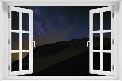 Fototapeta Naklejka Na Ścianę Okno 3D - Night starry sky. The Milky Way in the background of a mountain range.