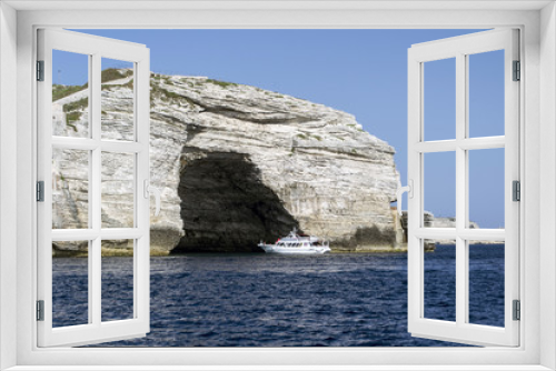 Fototapeta Naklejka Na Ścianę Okno 3D - white cruise ship in front of a rock formation with a cave near Bonifacio port on Corsica Island