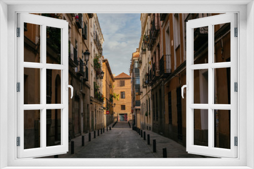 Fototapeta Naklejka Na Ścianę Okno 3D - Road Between Buildings in Spain