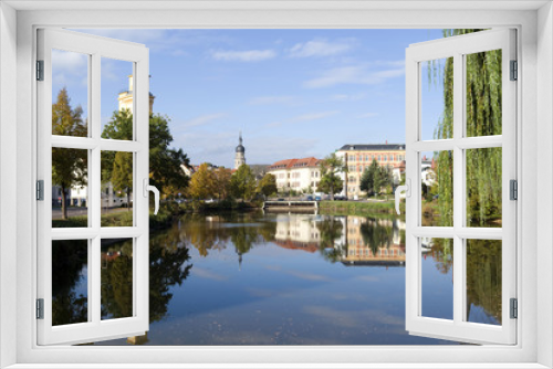 Fototapeta Naklejka Na Ścianę Okno 3D - Altenburg / Germany: Autumnal view over the „Little Pond“ to waterworks tower, St. Bartholomew steeple and Martin Luther School