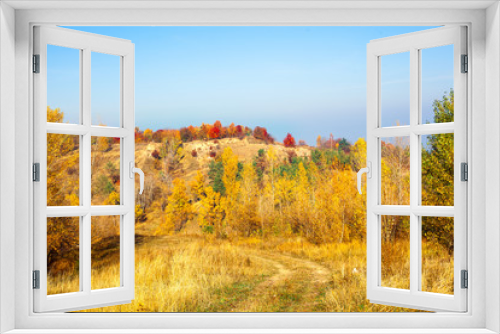 Fototapeta Naklejka Na Ścianę Okno 3D - Autumn hills, yellow grass, and blue sky landscape