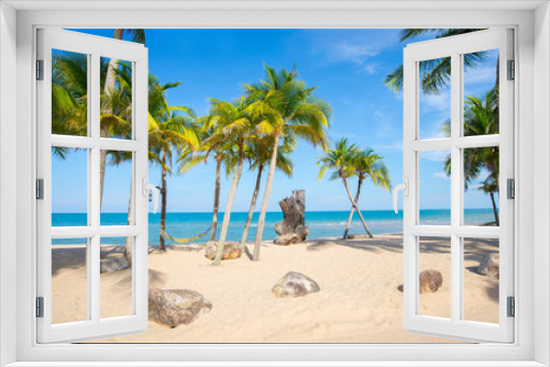 Fototapeta Naklejka Na Ścianę Okno 3D - Coconut trees lined beach by the sea with beautiful scenery.