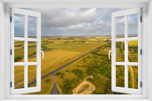 Fototapeta Naklejka Na Ścianę Okno 3D - Aerial scenic landscape of rural road passing through pastures and meadows in Australia