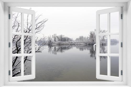 Fototapeta Naklejka Na Ścianę Okno 3D - Calm riverbank with reeds and trees in the winter