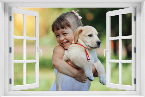 Fototapeta Naklejka Na Ścianę Okno 3D - Little girl with a Golden retriever puppy