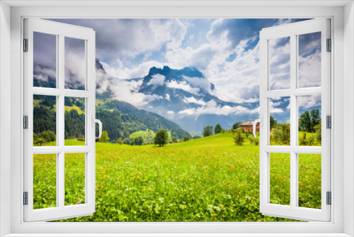 Fototapeta Naklejka Na Ścianę Okno 3D - Alpine scenery with green meadows and traditional mountain chalet in Grindelwald, Switzerland