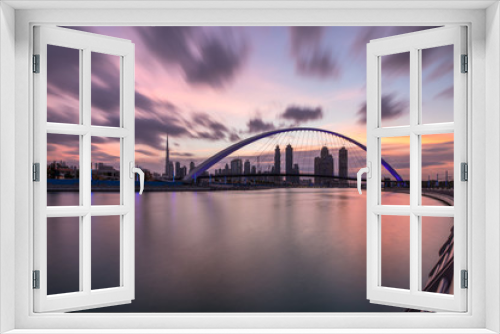 Fototapeta Naklejka Na Ścianę Okno 3D - Long exposure of stunning sunrise colors over Dubai Downtown and Dubai Water Canal. Dubai, UAE.