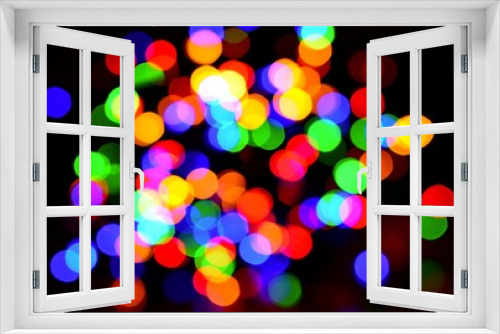 Colorful blurred bokeh lights on black background.