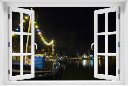 Fototapeta Naklejka Na Ścianę Okno 3D - Night view from the port of Helsinki in Finland. The lights of the boats and buildings are reflected on the dark water of the sea.