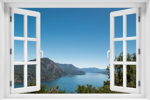 Fototapeta Naklejka Na Ścianę Okno 3D - Photo from the height with lake and mountains in the background and trees