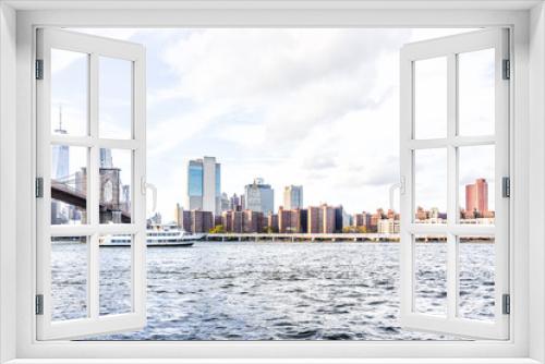 Fototapeta Naklejka Na Ścianę Okno 3D - East river water with view of NYC New York City cityscape skyline, Brooklyn bridge, ship boat ferry swimming by midtown