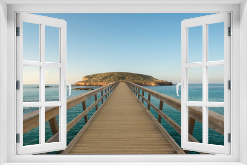 Fototapeta Naklejka Na Ścianę Okno 3D - Wooden footbridge by the water to an island