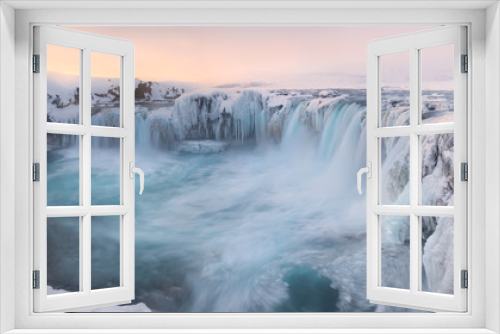 Fototapeta Naklejka Na Ścianę Okno 3D - Godafoss frozen waterfall during Winter at sunrise. North Iceland