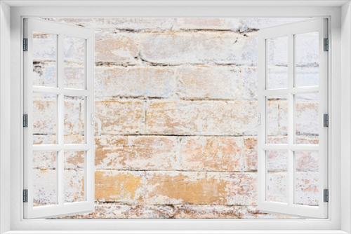 Fototapeta Naklejka Na Ścianę Okno 3D - Textured background of old yellow brickwork covered with cracked and partially falling off whitewash. Nice brick background in kraft style