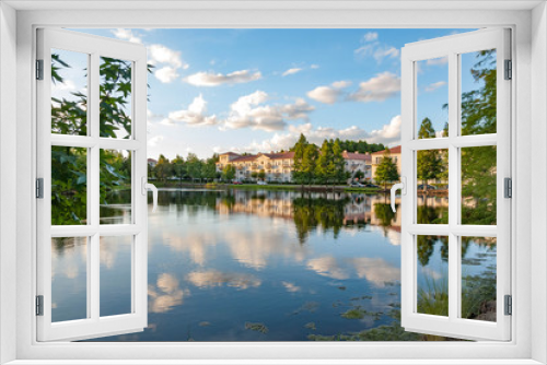 Fototapeta Naklejka Na Ścianę Okno 3D - Condos with lake view on sunny day with reflections