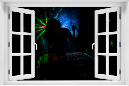 Fototapeta Naklejka Na Ścianę Okno 3D - DJ Spinning, Mixing, and Scratching in a Night Club, Hands of dj tweak various track controls on dj's deck, strobe lights and fog, or Dj mixes the track in the nightclub at party