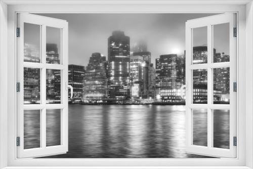 Fototapeta Naklejka Na Ścianę Okno 3D - Black and white picture of the Manhattan on a foggy night, New York City, USA.