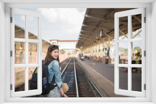 Asian tourist wait train at train station,thailand hipster womanman go to travel,Have a camera in hand