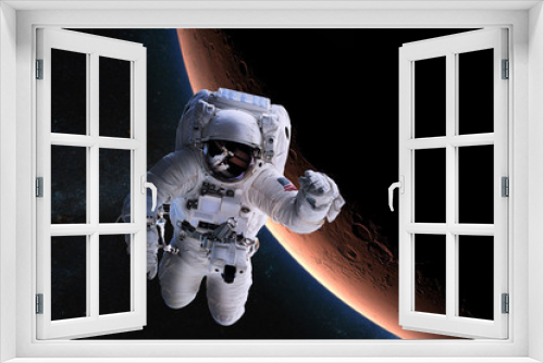 Fototapeta Naklejka Na Ścianę Okno 3D - Astronaut in outer space on background of the Mars. Elements of this image furnished by NASA.