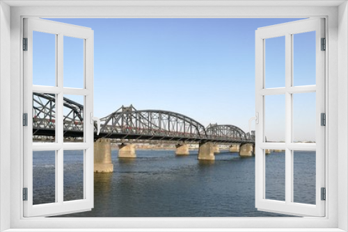 Fototapeta Naklejka Na Ścianę Okno 3D - Broken Bridge, Dandong, China (April, 2017) - opposite to Sinuiju city, North Korea; at Yalu river (natural border). It was bombed; repaired only part in China. Taken from public area in China.