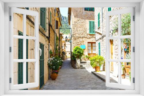 Fototapeta Naklejka Na Ścianę Okno 3D - Beautiful street in Valldemossa with traditional flower decoration, famous old mediterranean village of Majorca. Balearic island Mallorca, Spain