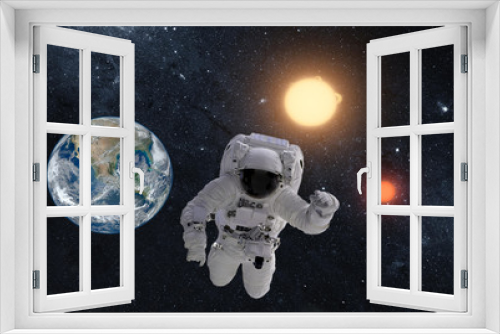 Fototapeta Naklejka Na Ścianę Okno 3D - Astronaut in outer space over the planet earth. This image is a collage of different images furnished by NASA