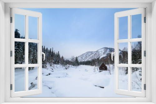 Fototapeta Naklejka Na Ścianę Okno 3D - Winter, a house in the mountains on the bank of a frozen river.

