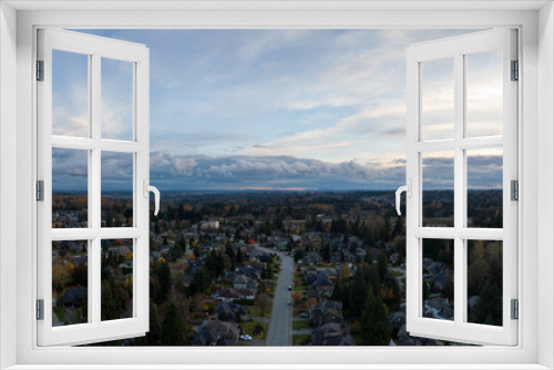 Fototapeta Naklejka Na Ścianę Okno 3D - Aerial panoramic view of a suburban neighborhood during a vibrant and cloudy sunset. Taken in Greater Vancouver, British Columbia, Canada.